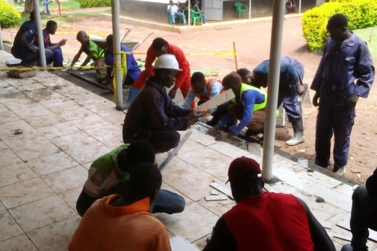 Building Students' placing tiles at the veranda of administration block